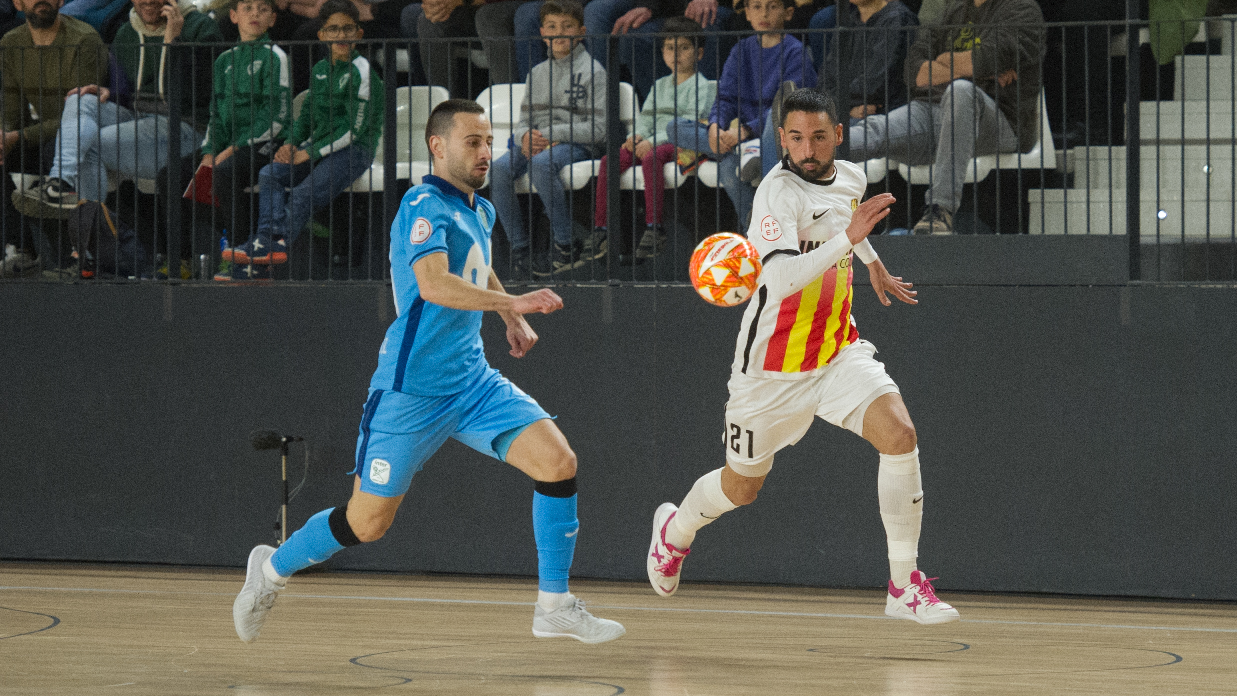 Álex Verdejo, de Industrias Santa Coloma, persigue el balón junto a Sepe, de Inter FS