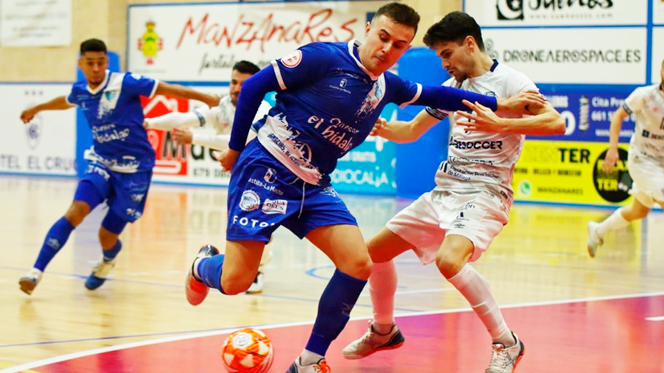 Daniel, jugador de Quesos El Hidalgo Manzanares, protege el balón frente a Pope, de BeSoccer CD UMA Antequera